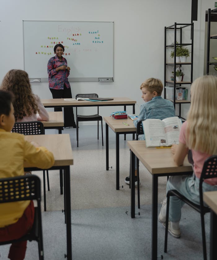 services-03 Classroom scene with a diverse group of students learning with a teacher.