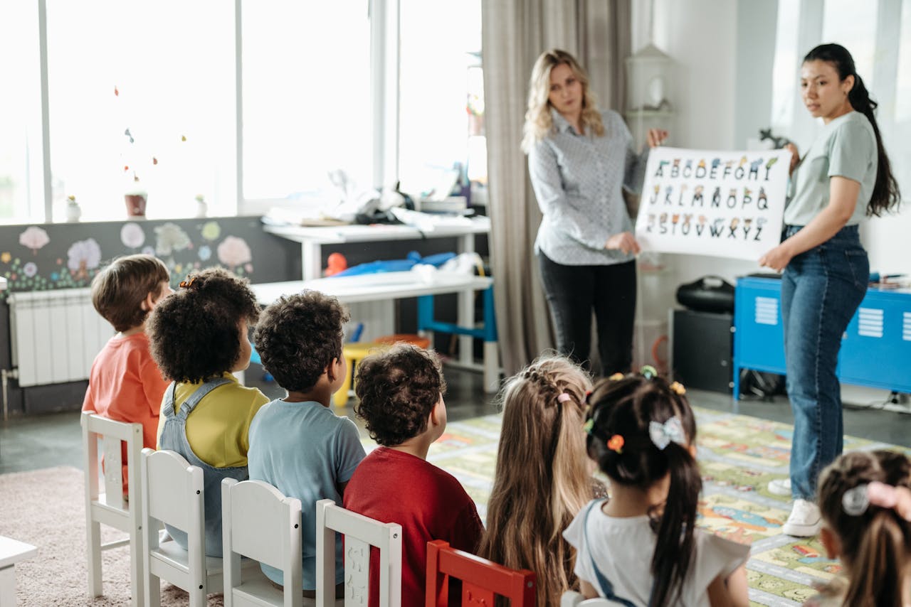 services-01 Teachers engage children in learning alphabet during a kindergarten class.